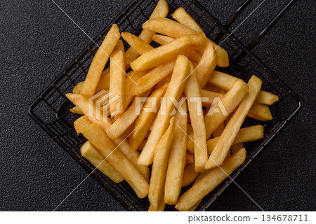 French fries are salty, crispy, and fried in oil, unhealthy takeaway food. French fries 134678711