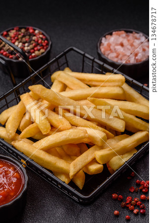 French fries are salty, crispy, and fried in oil, unhealthy takeaway food. French fries 134678717