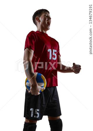 Volleyball player holding ball joyfully celebrating victory 134679191