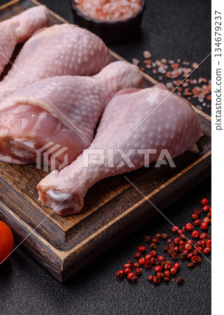 Raw chicken legs, poultry meat on the bone for barbecue. Chicken legs as a food background Raw chicken legs, poultry meat on the bone for barbecue. Chicken legs as a food background 134679237
