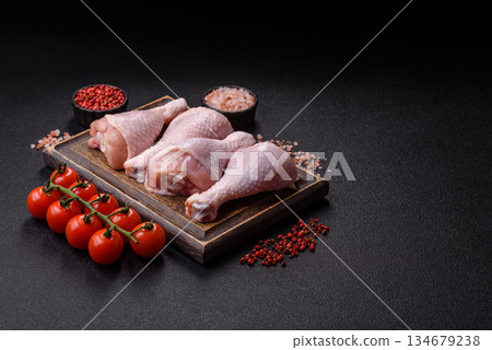 Raw chicken legs, poultry meat on the bone for barbecue. Chicken legs as a food background Raw chicken legs, poultry meat on the bone for barbecue. Chicken legs as a food background 134679238