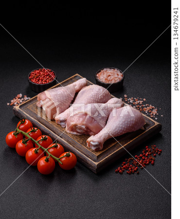 Raw chicken legs, poultry meat on the bone for barbecue. Chicken legs as a food background Raw chicken legs, poultry meat on the bone for barbecue. Chicken legs as a food background 134679241