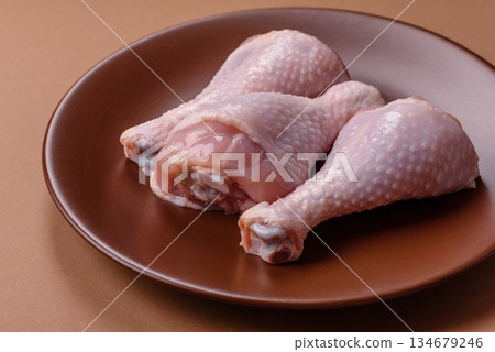 Raw chicken legs, poultry meat on the bone for barbecue. Chicken legs as a food background 134679246