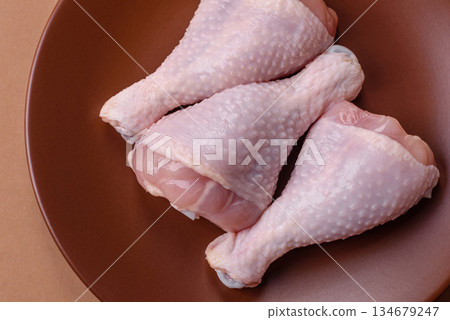 Raw chicken legs, poultry meat on the bone for barbecue. Chicken legs as a food background 134679247