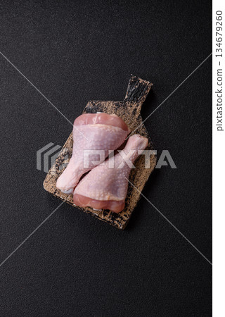 Raw chicken legs, poultry meat on the bone for barbecue. Chicken legs as a food background Raw chicken legs, poultry meat on the bone for barbecue. Chicken legs as a food background 134679260
