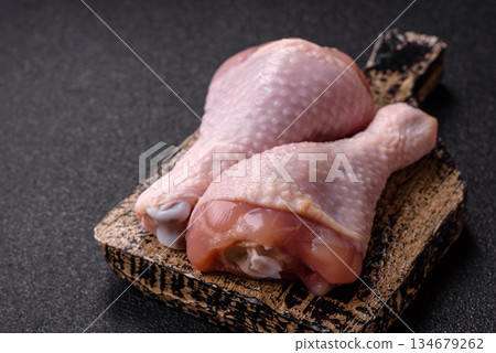 Raw chicken legs, poultry meat on the bone for barbecue. Chicken legs as a food background 134679262