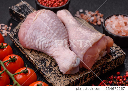 Raw chicken legs, poultry meat on the bone for barbecue. Chicken legs as a food background 134679267