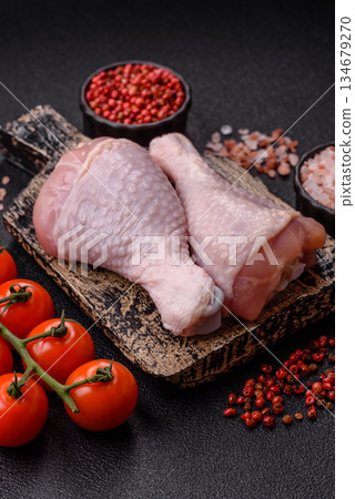 Raw chicken legs, poultry meat on the bone for barbecue. Chicken legs as a food background 134679270