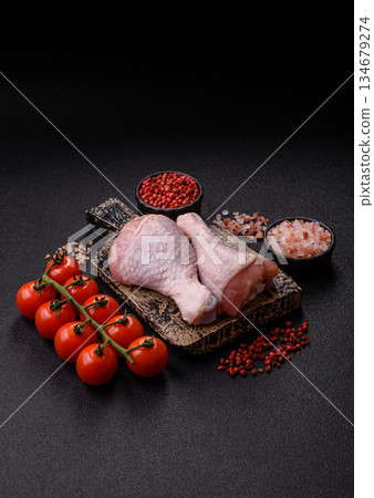 Raw chicken legs, poultry meat on the bone for barbecue. Chicken legs as a food background 134679274