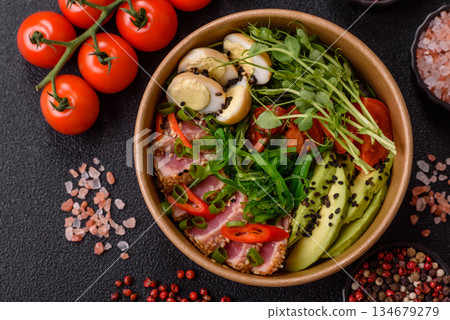 Seared tuna tataki in a bowl with sesame seeds, rice, and vegetables. Tuna tataki Seared tuna tataki in a bowl with sesame seeds, rice, and vegetables. Tuna tataki 134679279