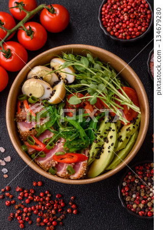 Seared tuna tataki in a bowl with sesame seeds, rice, and vegetables. Tuna tataki Seared tuna tataki in a bowl with sesame seeds, rice, and vegetables. Tuna tataki 134679280