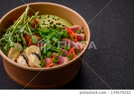 Seared tuna tataki in a bowl with sesame seeds, rice, and vegetables. Tuna tataki Seared tuna tataki in a bowl with sesame seeds, rice, and vegetables. Tuna tataki 134679282
