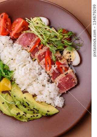 Seared tuna tataki in a bowl with sesame seeds, rice, and vegetables. Tuna tataki Seared tuna tataki in a bowl with sesame seeds, rice, and vegetables. Tuna tataki 134679299