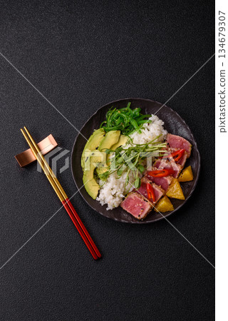 Seared tuna tataki in a bowl with sesame seeds, rice, and vegetables. Tuna tataki Seared tuna tataki in a bowl with sesame seeds, rice, and vegetables. Tuna tataki 134679307