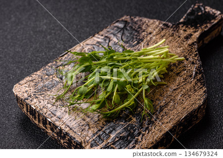 Fresh green sprouts of pea microgreens for a healthy detox meal. Sprout pea microgreens Fresh green sprouts of pea microgreens for a healthy detox meal. Sprout pea microgreens 134679324