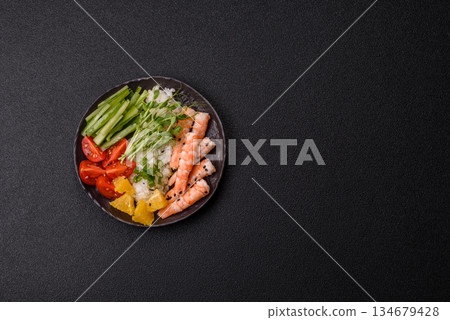 A prawn or shrimp bowl with rice, tomatoes, sauce, and vegetables, Asian food. Prawn or shrimp A prawn or shrimp bowl with rice, tomatoes, sauce, and vegetables, Asian food. Prawn or shrimp 134679428