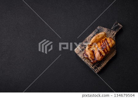 Grilled boneless chicken legs baked on the barbecue for lunch. Grilled chicken as a background Grilled boneless chicken legs baked on the barbecue for lunch. Grilled chicken as a background 134679504