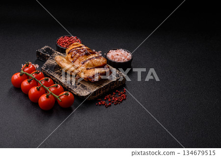 Grilled boneless chicken legs baked on the barbecue for lunch. Grilled chicken as a background 134679515