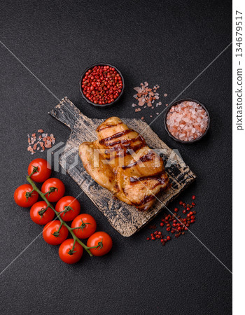 Grilled boneless chicken legs baked on the barbecue for lunch. Grilled chicken as a background Grilled boneless chicken legs baked on the barbecue for lunch. Grilled chicken as a background 134679517