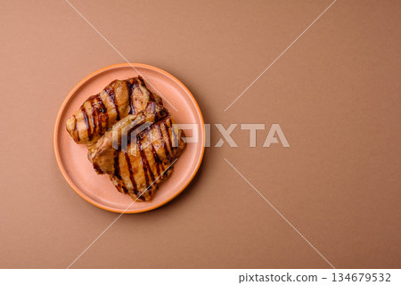 Grilled boneless chicken legs baked on the barbecue for lunch. Grilled chicken as a background 134679532