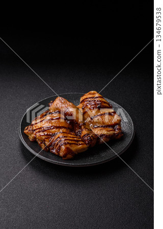 Grilled boneless chicken legs baked on the barbecue for lunch. Grilled chicken as a background Grilled boneless chicken legs baked on the barbecue for lunch. Grilled chicken as a background 134679538