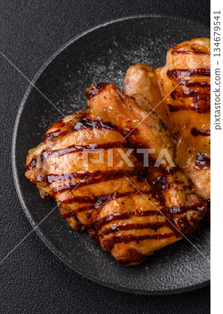 Grilled boneless chicken legs baked on the barbecue for lunch. Grilled chicken as a background 134679541