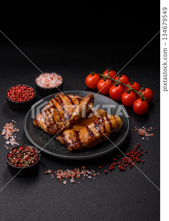 Grilled boneless chicken legs baked on the barbecue for lunch. Grilled chicken as a background Grilled boneless chicken legs baked on the barbecue for lunch. Grilled chicken as a background 134679549