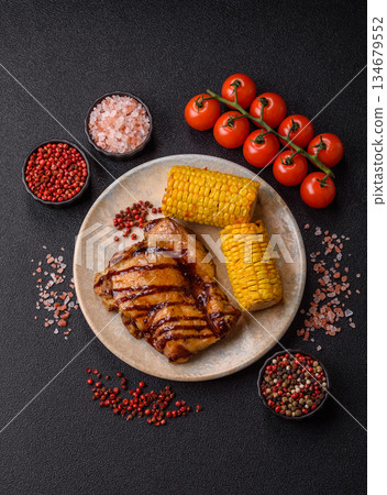 Grilled boneless chicken legs baked on the barbecue for lunch. Grilled chicken as a background Grilled boneless chicken legs baked on the barbecue for lunch. Grilled chicken as a background 134679552