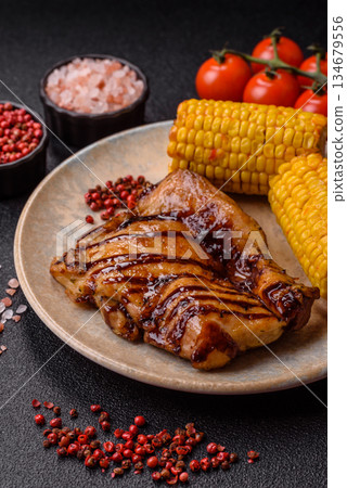 Grilled boneless chicken legs baked on the barbecue for lunch. Grilled chicken as a background 134679556