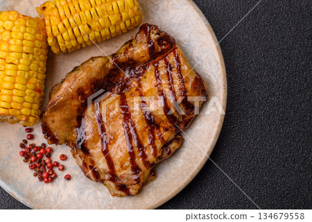 Grilled boneless chicken legs baked on the barbecue for lunch. Grilled chicken as a background Grilled boneless chicken legs baked on the barbecue for lunch. Grilled chicken as a background 134679558