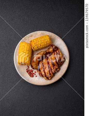 Grilled boneless chicken legs baked on the barbecue for lunch. Grilled chicken as a background 134679570