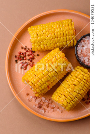 Corn cob cooked in chunks, vegetables, healthy vegetarian food. Boiled corn as a background Corn cob cooked in chunks, vegetables, healthy vegetarian food. Boiled corn as a background 134679581