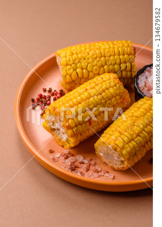 Corn cob cooked in chunks, vegetables, healthy vegetarian food. Boiled corn as a background Corn cob cooked in chunks, vegetables, healthy vegetarian food. Boiled corn as a background 134679582