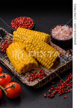 Corn cob cooked in chunks, vegetables, healthy vegetarian food. Boiled corn as a background 134679601
