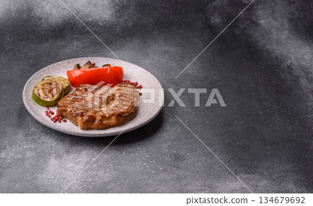 Grilled beef or pork steak, healthy restaurant food for lunch. Barbecue steak as a background Grilled beef or pork steak, healthy restaurant food for lunch. Barbecue steak as a background 134679692