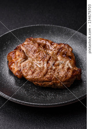 Grilled beef or pork steak, healthy restaurant food for lunch. Barbecue steak as a background 134679703