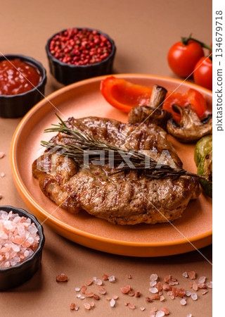 Grilled beef or pork steak, healthy restaurant food for lunch. Barbecue steak as a background Grilled beef or pork steak, healthy restaurant food for lunch. Barbecue steak as a background 134679718