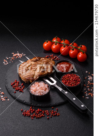 Grilled beef or pork steak, healthy restaurant food for lunch. Barbecue steak as a background 134679730