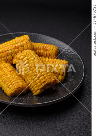 Corn cob cooked in chunks, vegetables, healthy vegetarian food. Boiled corn as a background Corn cob cooked in chunks, vegetables, healthy vegetarian food. Boiled corn as a background 134679753