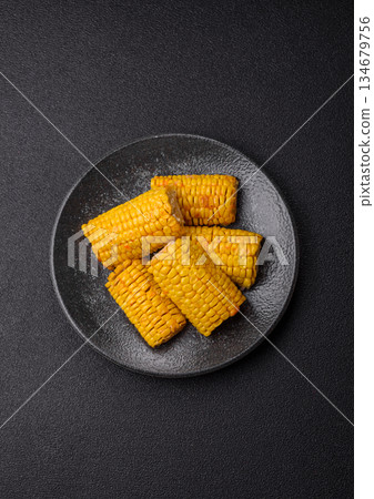 Corn cob cooked in chunks, vegetables, healthy vegetarian food. Boiled corn as a background Corn cob cooked in chunks, vegetables, healthy vegetarian food. Boiled corn as a background 134679756