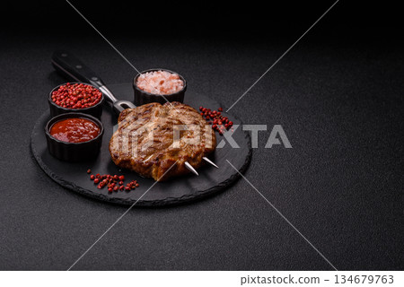 Grilled beef or pork steak, healthy restaurant food for lunch. Barbecue steak as a background Grilled beef or pork steak, healthy restaurant food for lunch. Barbecue steak as a background 134679763