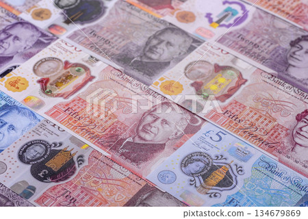 Britain paper money, pound sterling, cash banknotes for financial transactions. Britain money 134679869