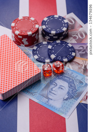 Casino game in the Great Britain, pound sterling money, chips, cards. Gambling in the England Casino game in the Great Britain, pound sterling money, chips, cards. Gambling in the England 134679896