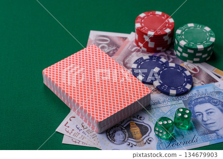 Casino game in the Great Britain, pound sterling money, chips, cards. Gambling in the England Casino game in the Great Britain, pound sterling money, chips, cards. Gambling in the England 134679903