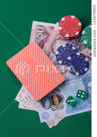 Casino game in the Great Britain, pound sterling money, chips, cards. Gambling in the England Casino game in the Great Britain, pound sterling money, chips, cards. Gambling in the England 134679905