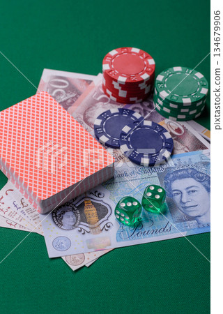 Casino game in the Great Britain, pound sterling money, chips, cards. Gambling in the England Casino game in the Great Britain, pound sterling money, chips, cards. Gambling in the England 134679906