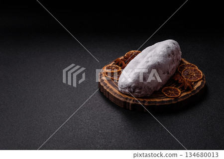 Stollen, a German Christmas pastry for the winter holidays. Stollen as a food background Stollen, a German Christmas pastry for the winter holidays. Stollen as a food background 134680013