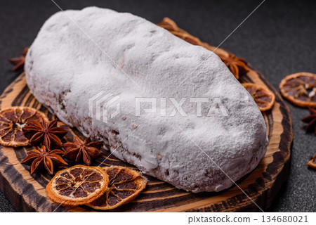 Stollen, a German Christmas pastry for the winter holidays. Stollen as a food background Stollen, a German Christmas pastry for the winter holidays. Stollen as a food background 134680021