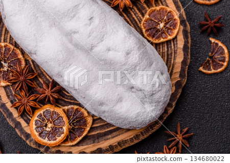 Stollen, a German Christmas pastry for the winter holidays. Stollen as a food background Stollen, a German Christmas pastry for the winter holidays. Stollen as a food background 134680022