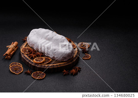 Stollen, a German Christmas pastry for the winter holidays. Stollen as a food background Stollen, a German Christmas pastry for the winter holidays. Stollen as a food background 134680025